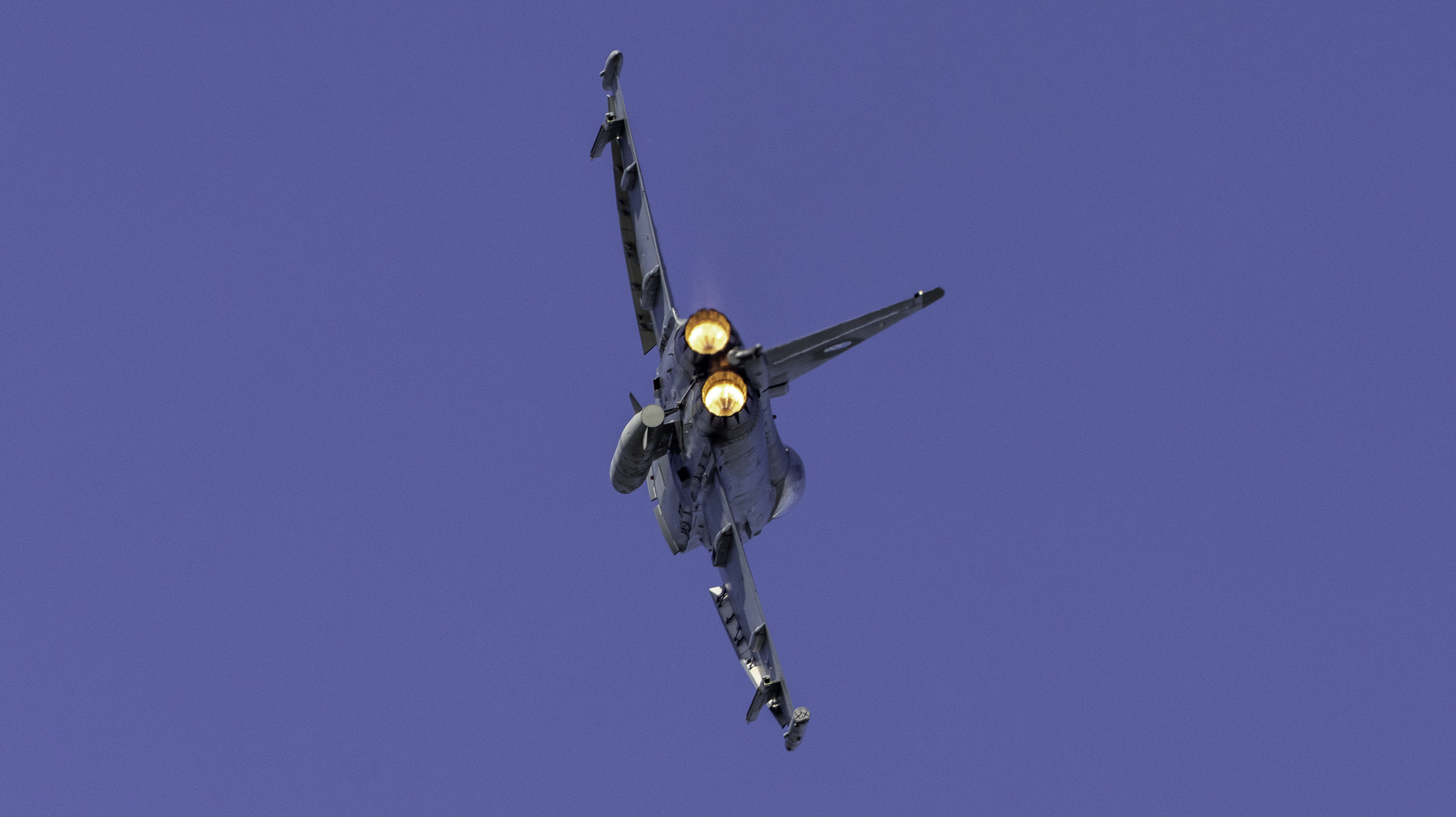 Eurofighter Typhoon climbing away with both afterburners lit, seen from behind