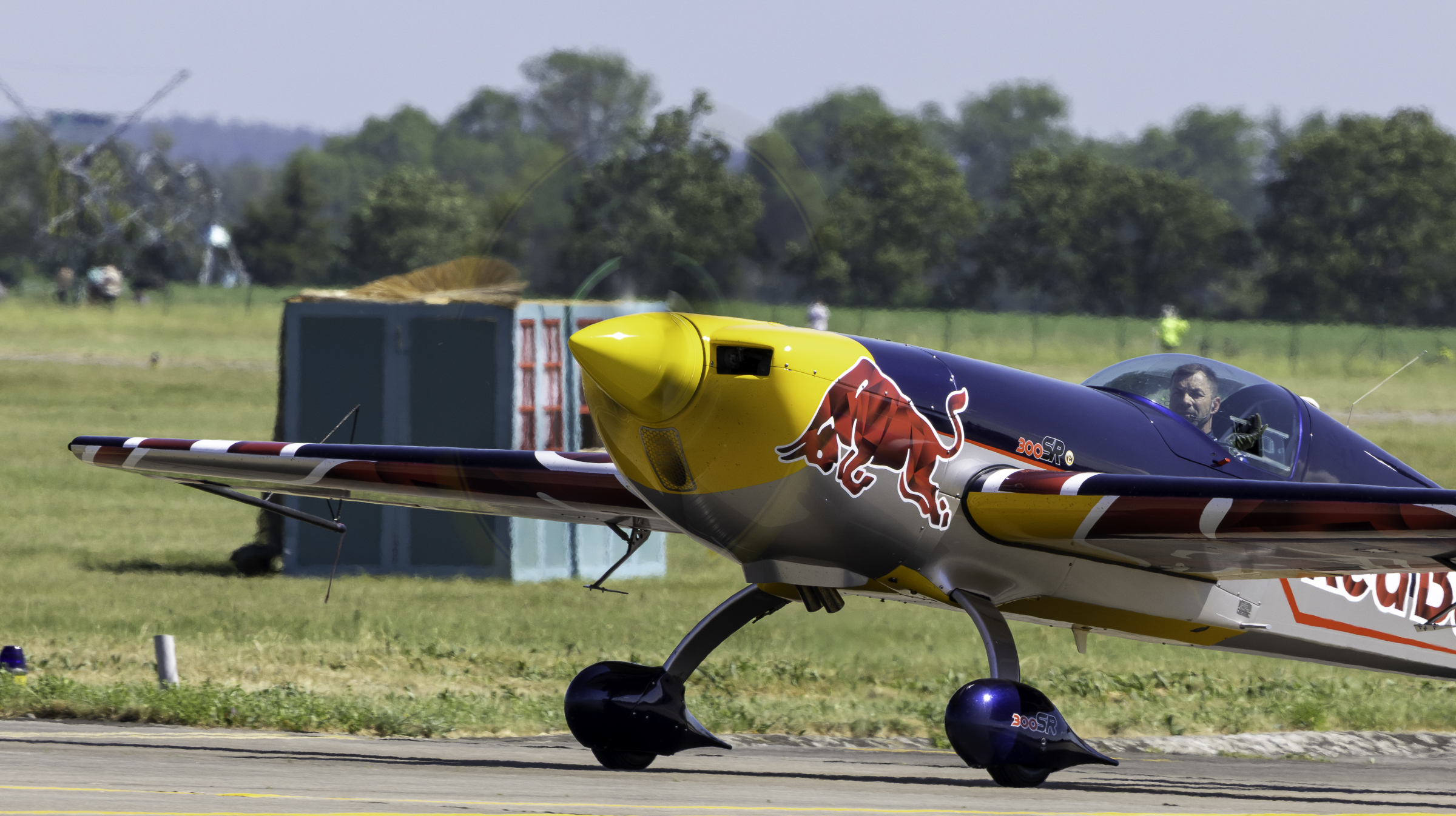 Red Bull Extra 300SR aerobatic plane taxiing, pilot visible under the canopy