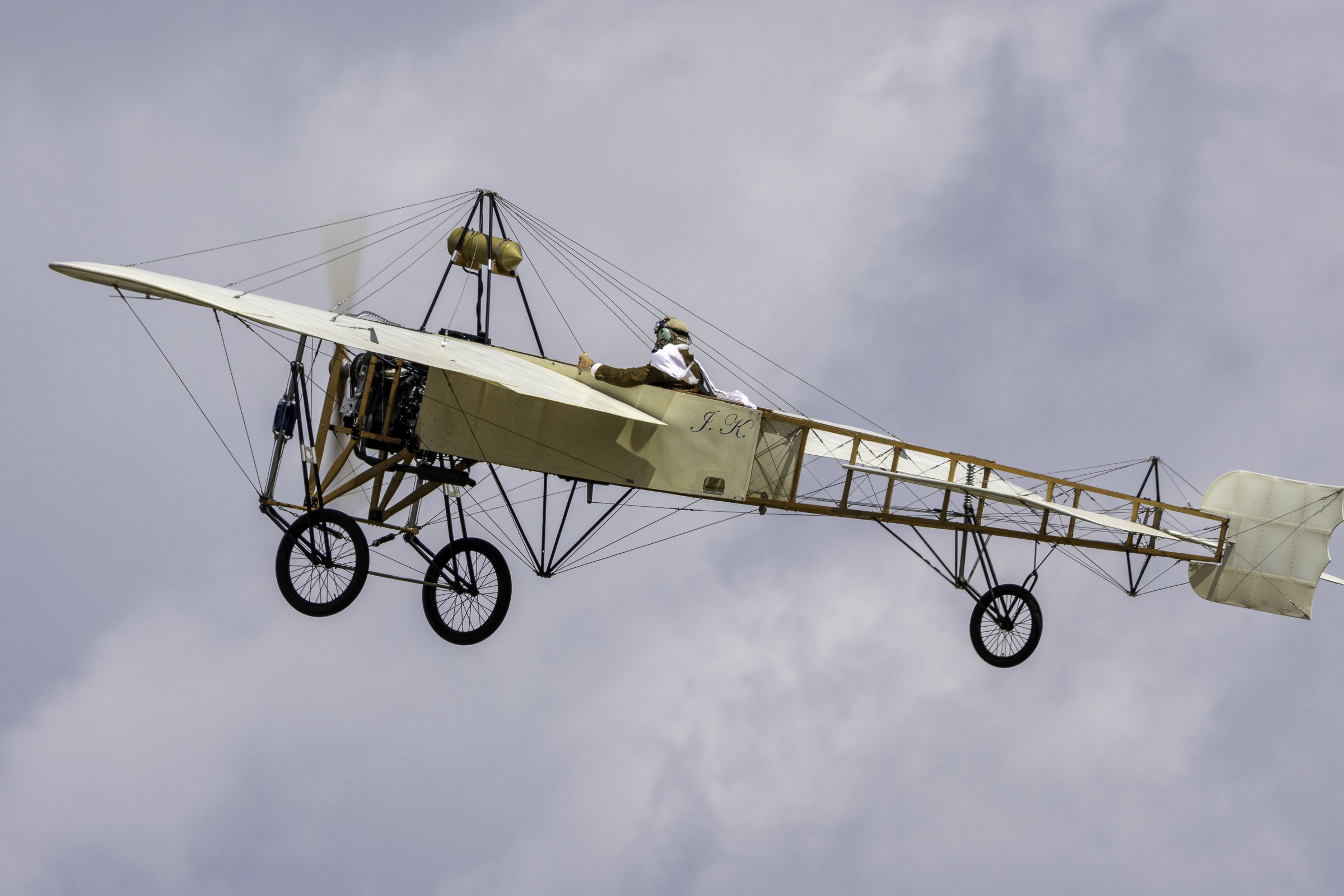 Blériot XI replica monoplane in flight with the pilot in period clothing