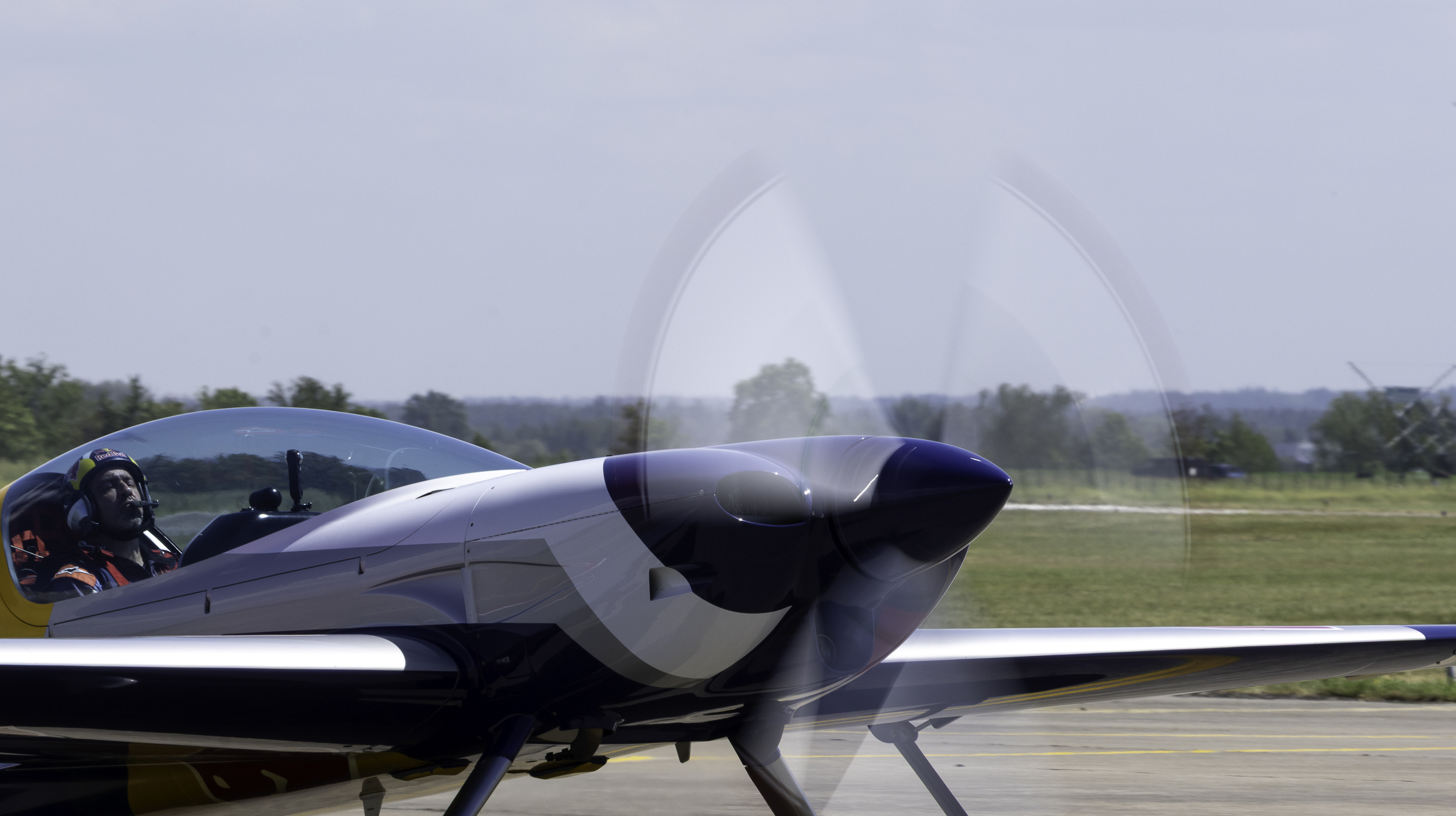 Close-up of the Red Bull Extra 300SR nose and blurred propeller while taxiing