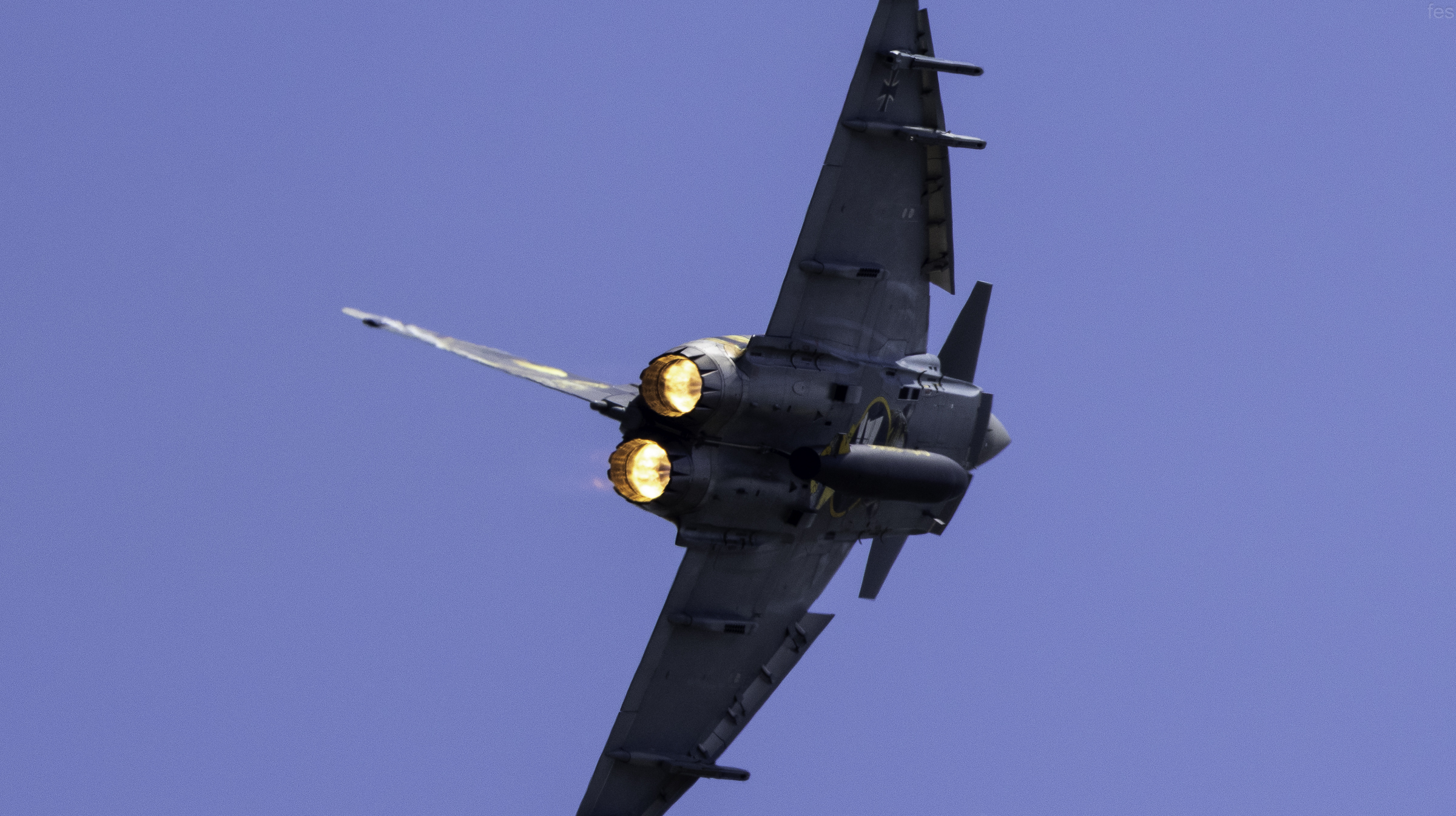 Eurofighter Typhoon pulling a tight turn with both afterburners glowing