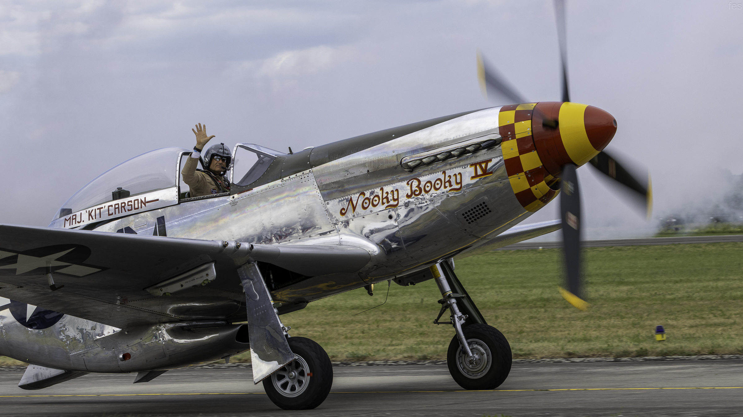 P-51D Mustang 'Nooky Booky IV' taxiing with the pilot waving from the cockpit